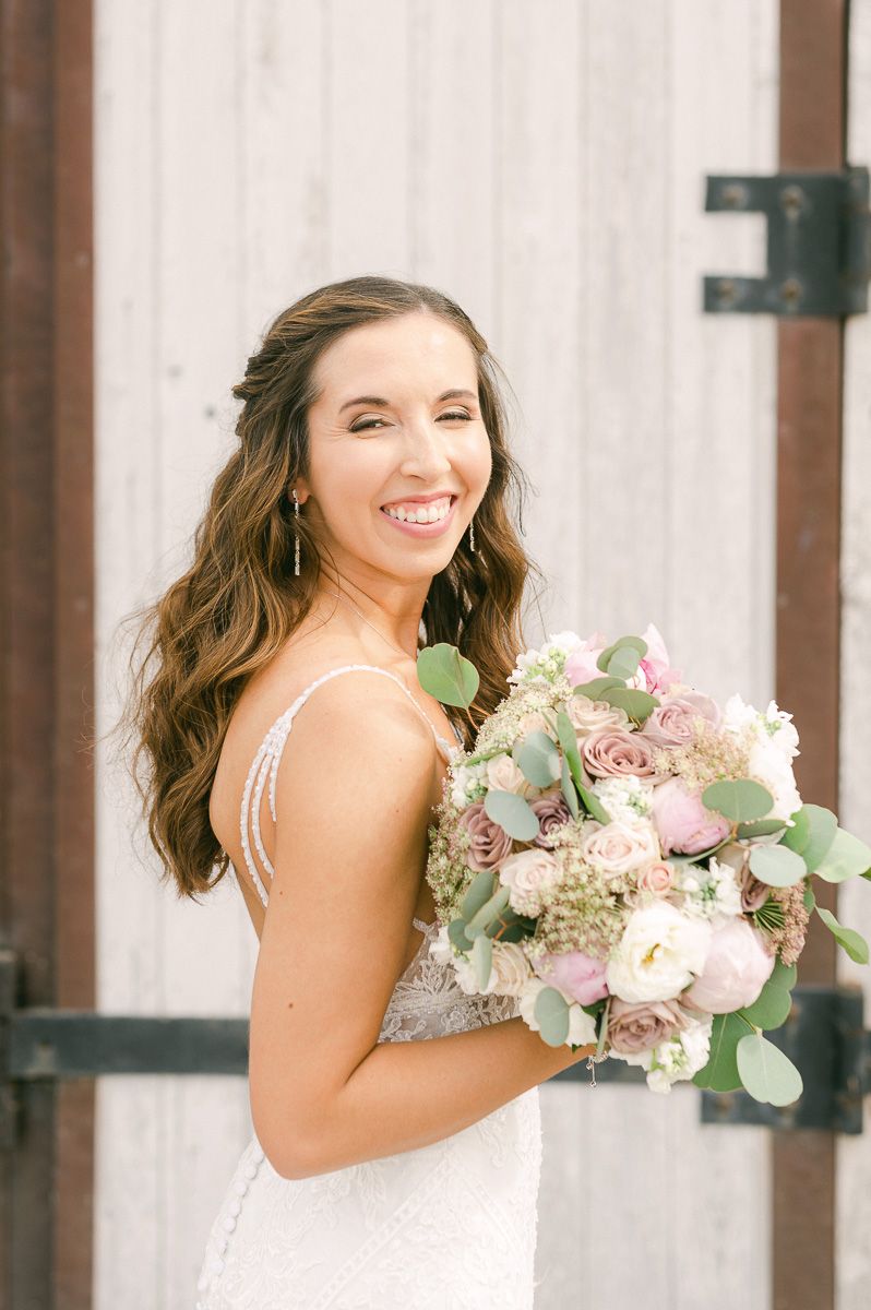 bride holding bouquet outside Beckendorff Farms in Katy, Tx