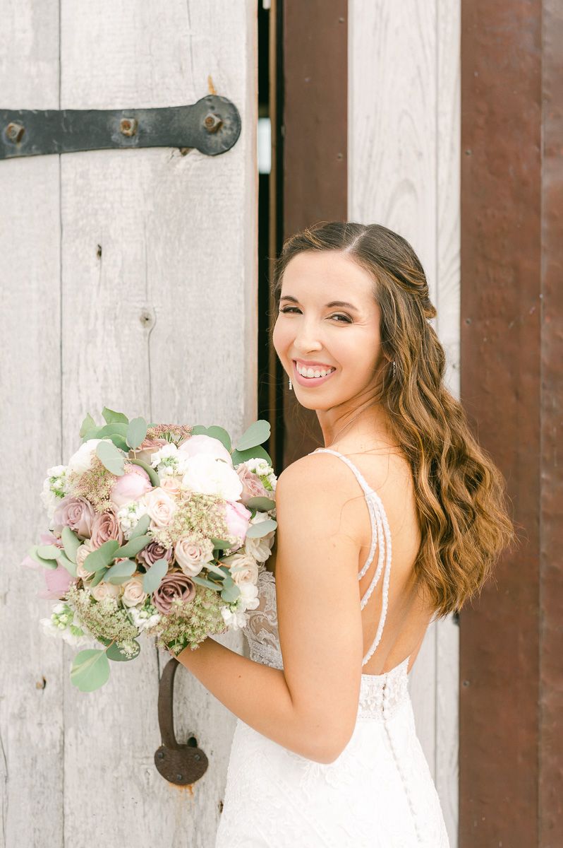 bride holding bouquet outside Beckendorff Farms in Katy, Tx