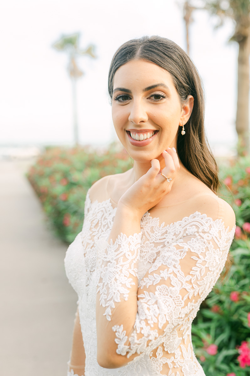 a bride near a pink flower bush in galveston