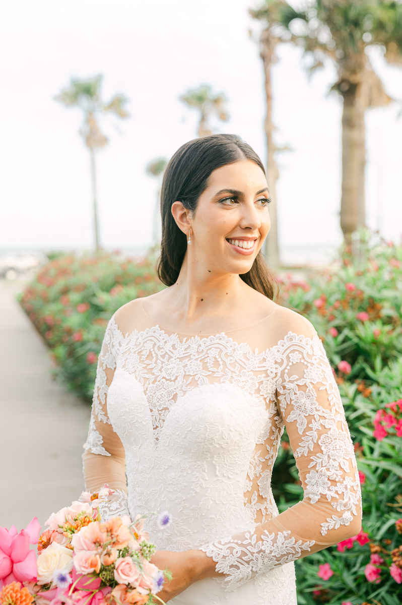 a bride near a pink flower bush in galveston