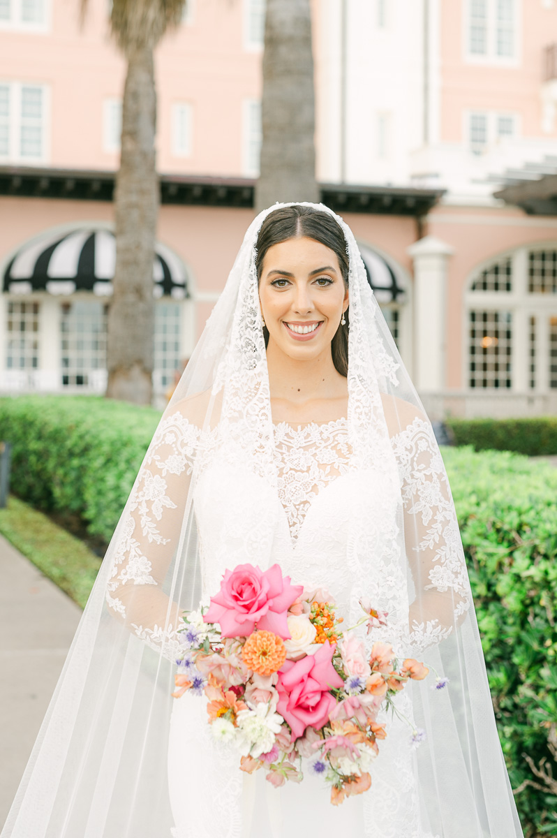 a bride wearing a classic veil and lace dress