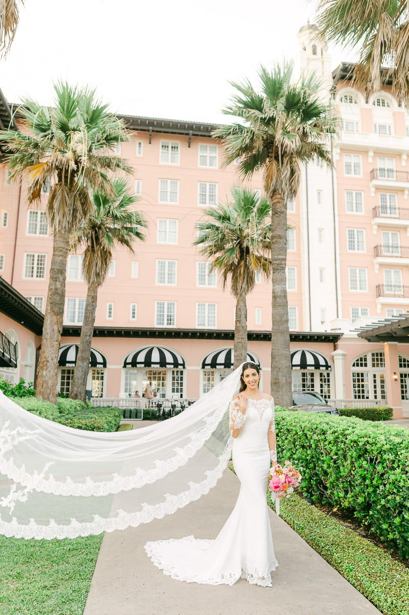 a bride with a long wedding veil in galveston