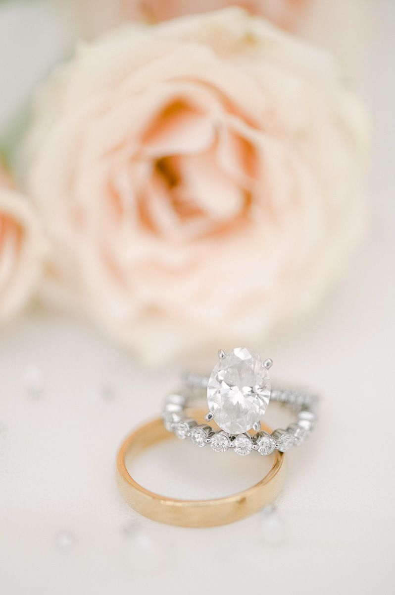 wedding rings on veil with pink flower