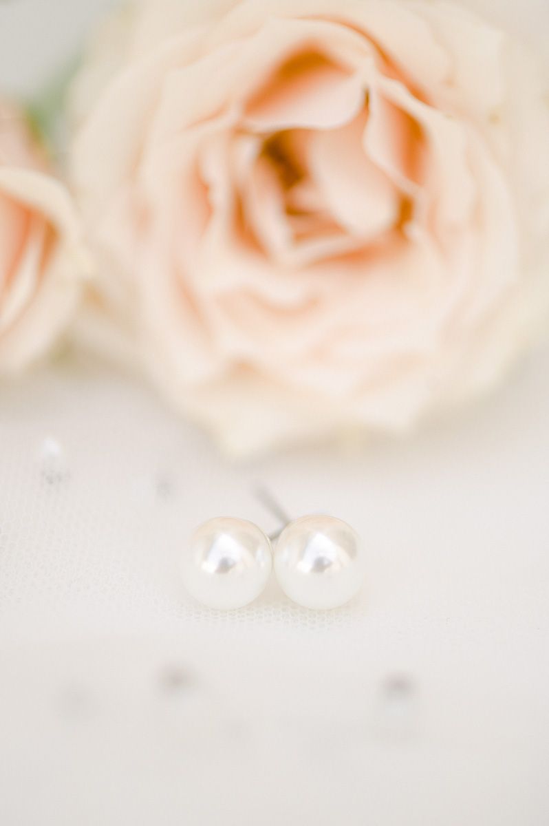wedding earrings on veil with pink flower