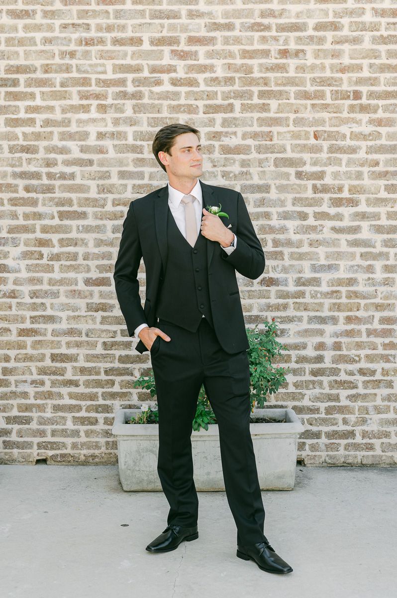 groom in black suit at Montgomery, Tx wedding