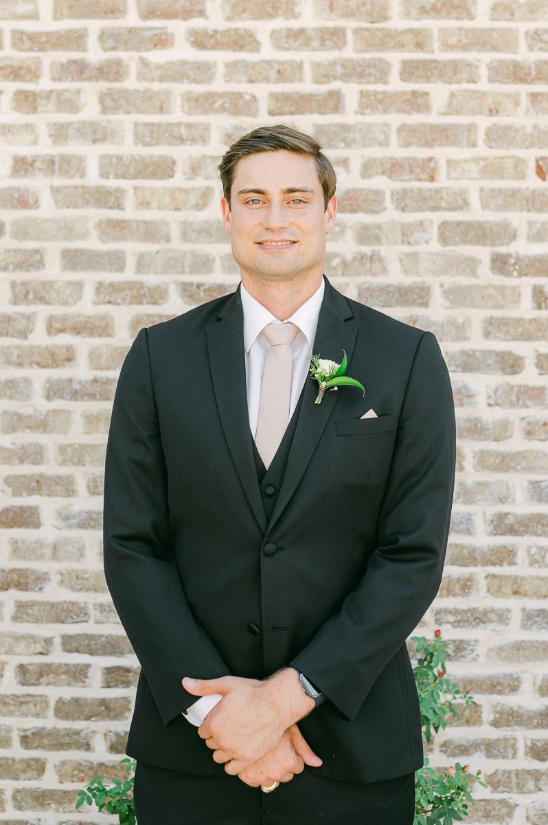 groom in black suit at Montgomery, Tx wedding