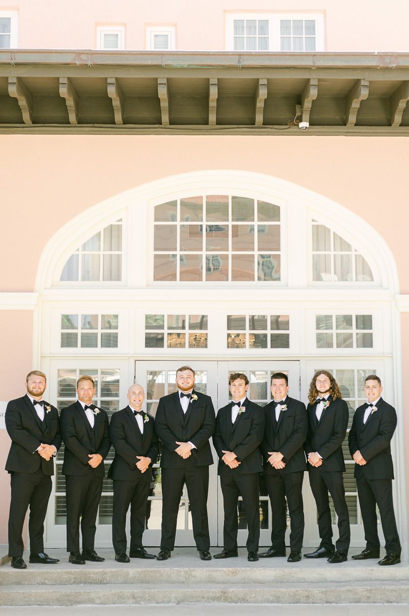 groomsmen in black suits at Grand Galvez