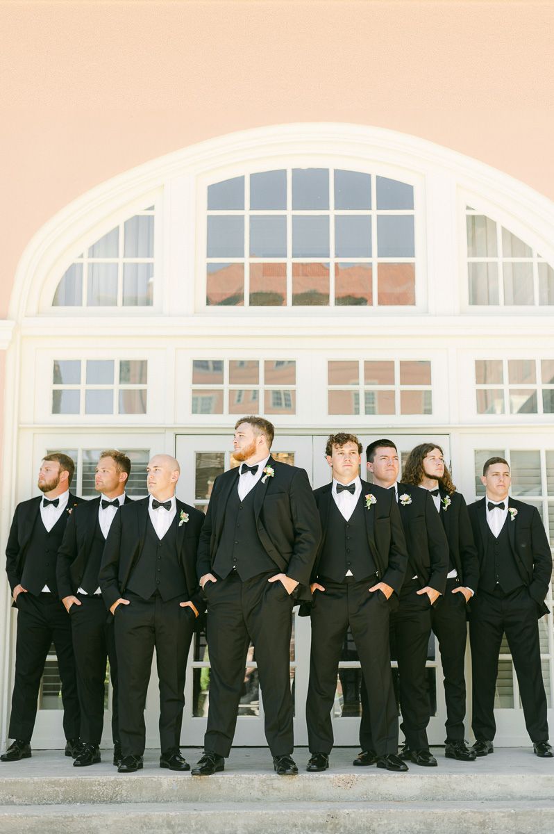 groomsmen in black suits at Grand Galvez