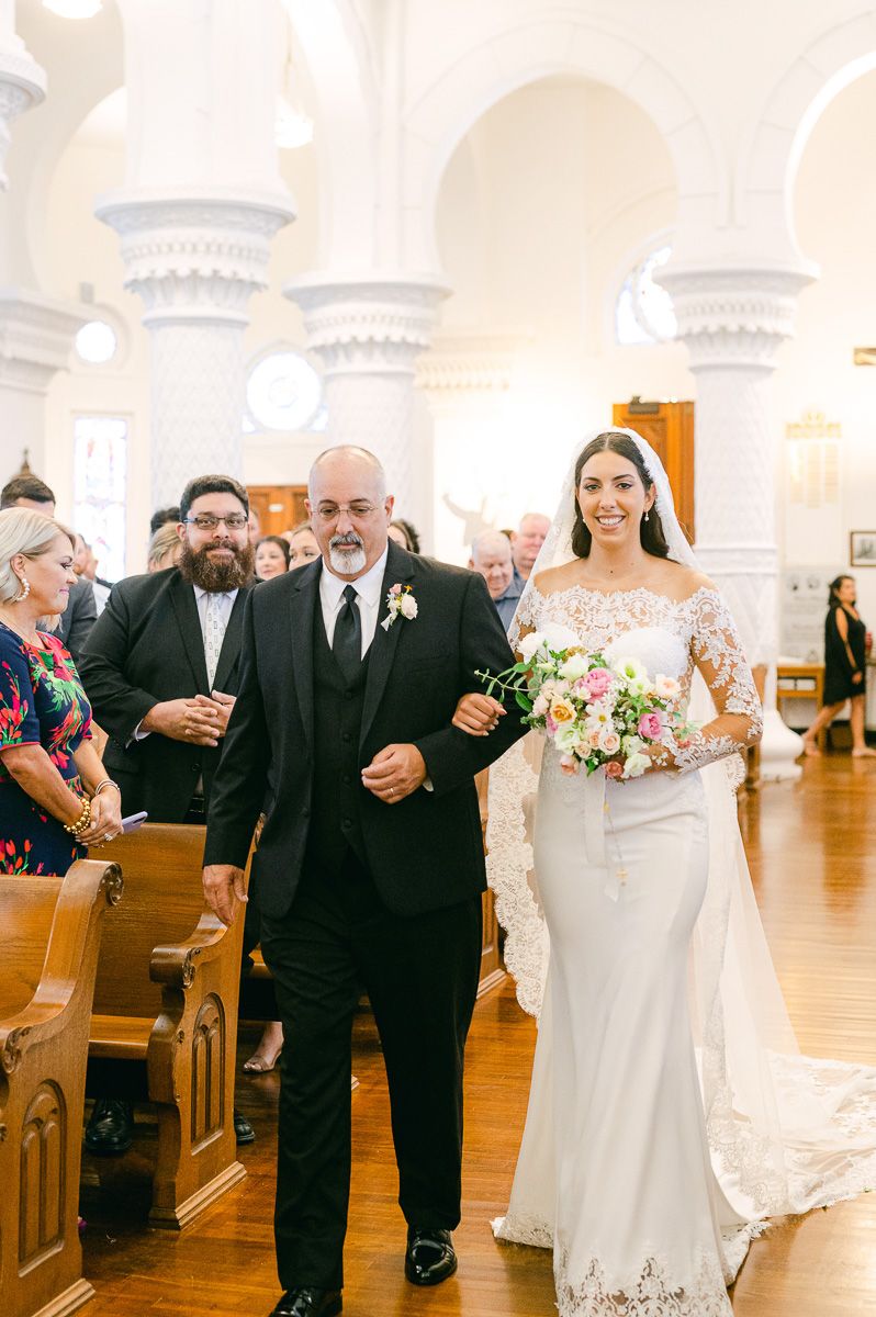 bride walking up the aisle in Catholic Church 