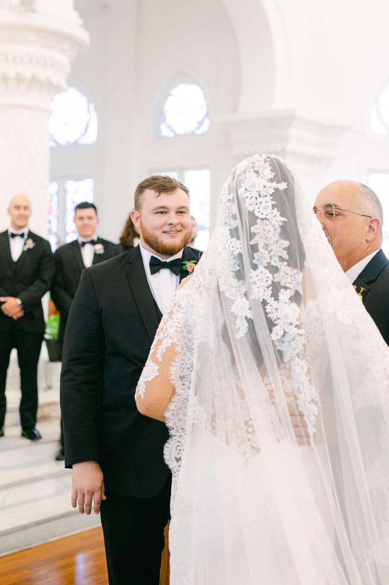 bride walking up the aisle in Catholic Church 