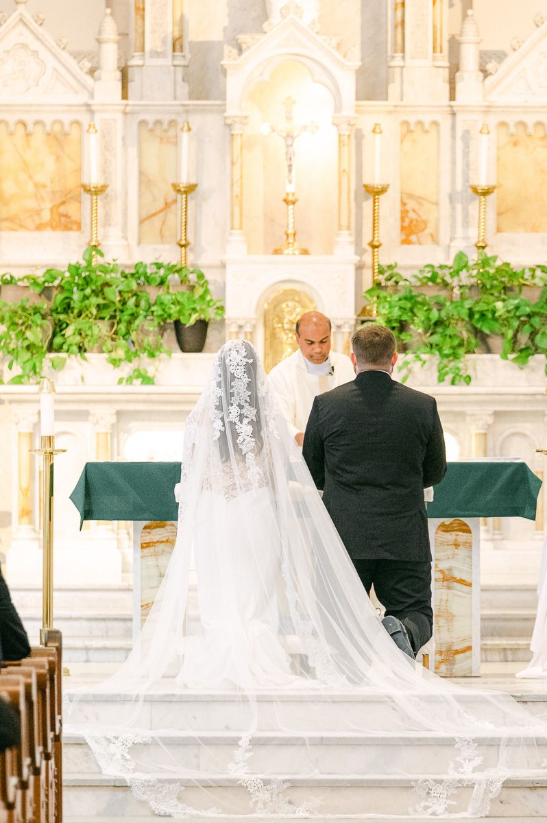 couple kneeling during catholic ceremony