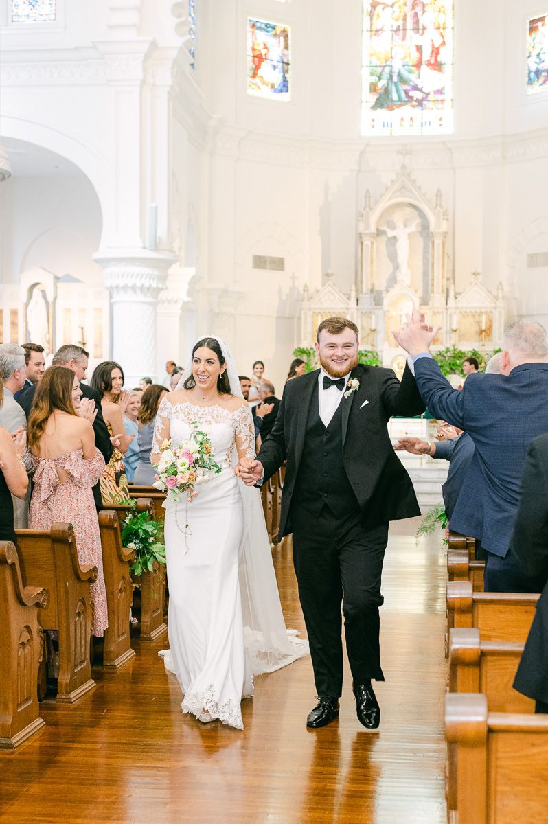 couple leaving Sacred Heart Catholic Church ceremony