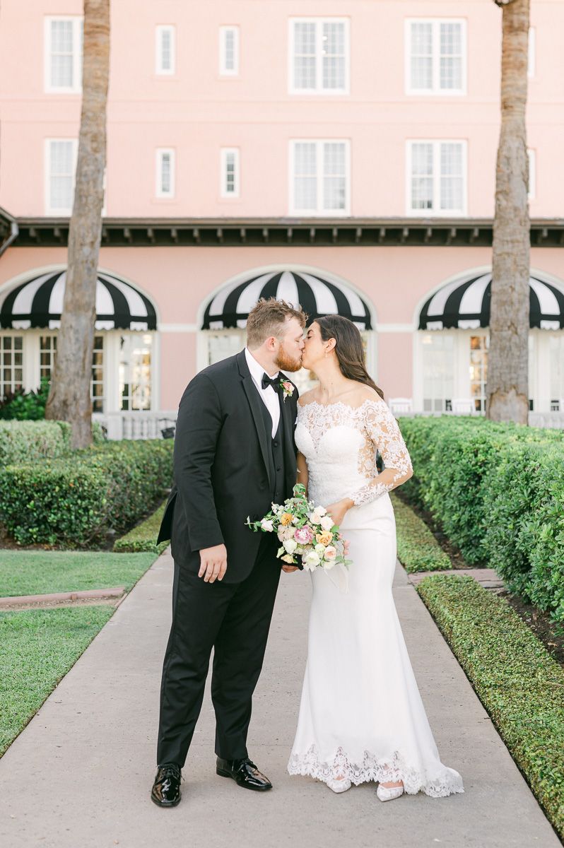 couple kissing in front of the Grand Galvez
