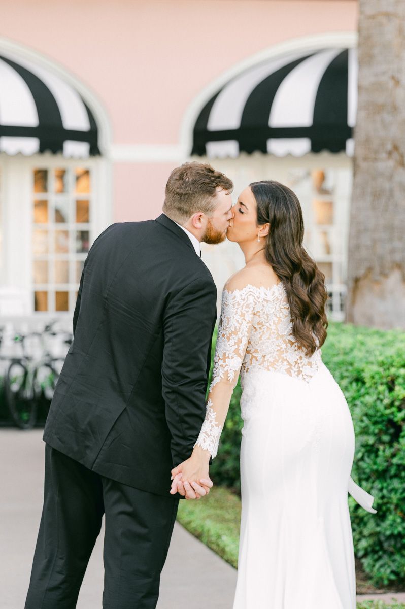 couple kissing in front of the Grand Galvez