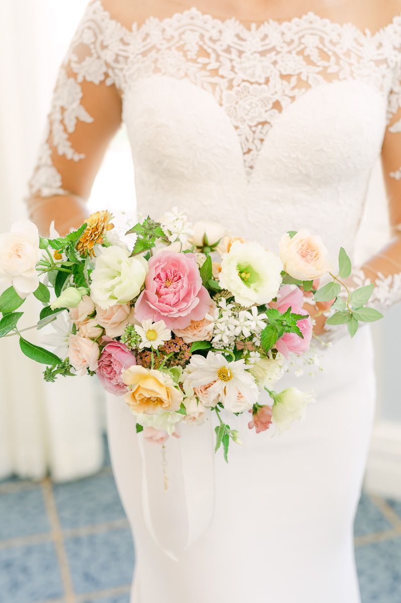 bride holding vibrant spring bouquet