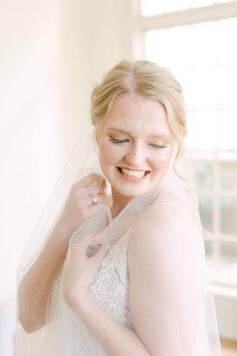 bride hugging her veil during bridal session