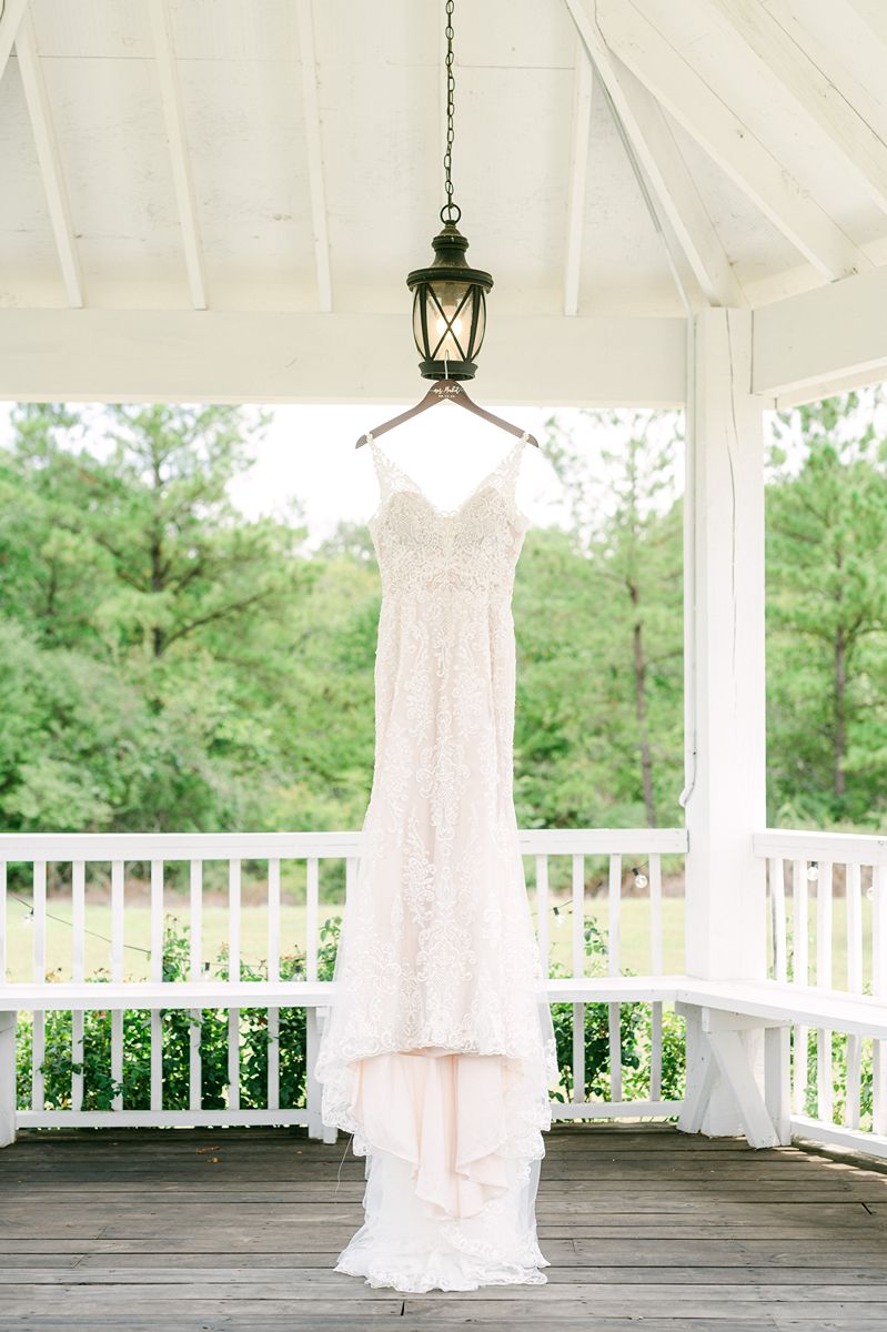 wedding dress hanging in gazebo