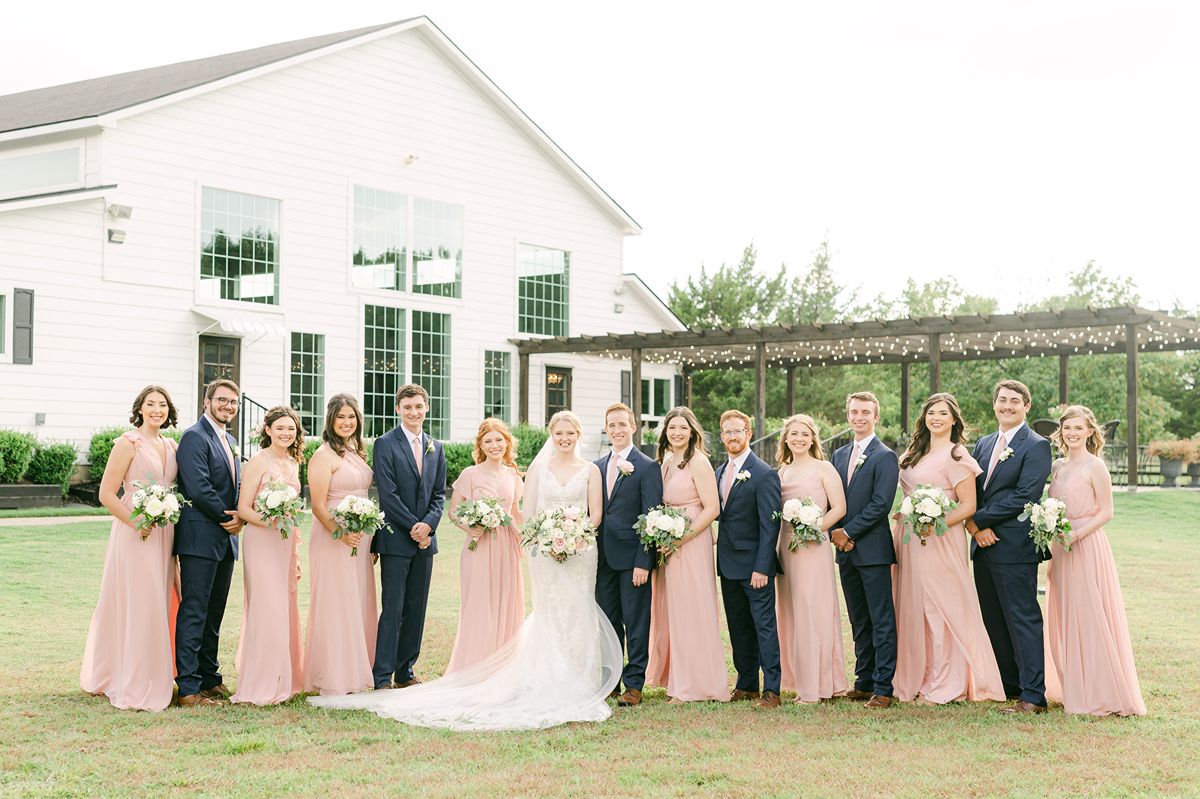 wedding party wearing pink dresses and navy suits in Texas