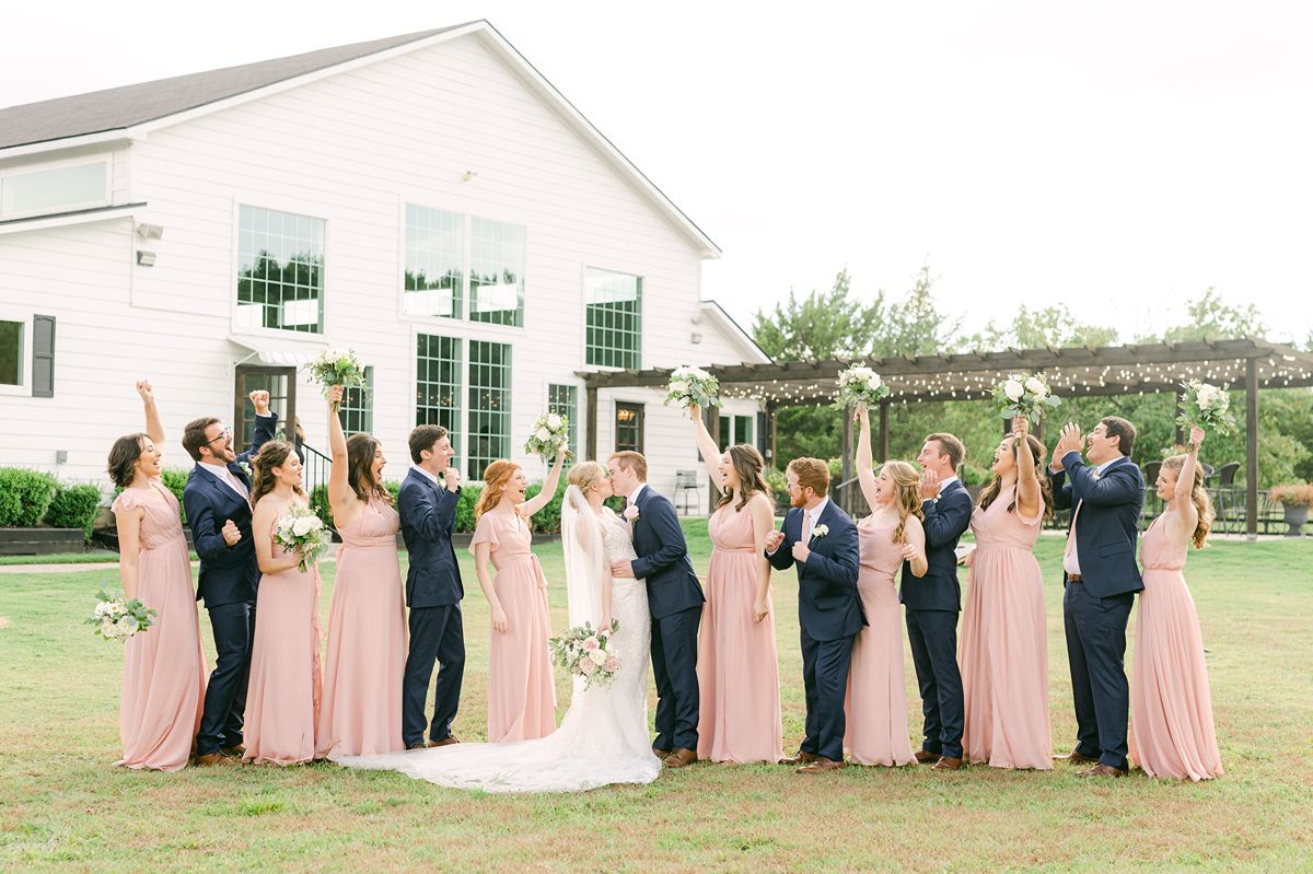 wedding party wearing pink dresses and navy suits in Texas
