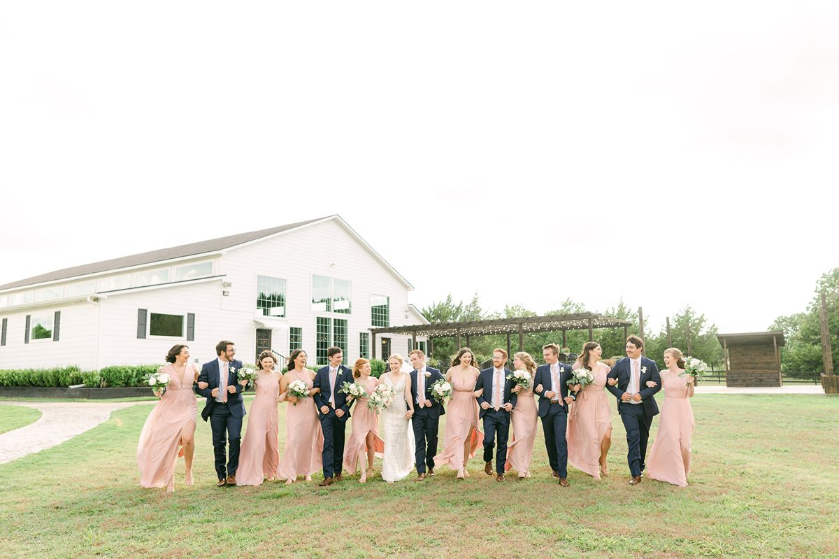 wedding party wearing pink dresses and navy suits in Texas