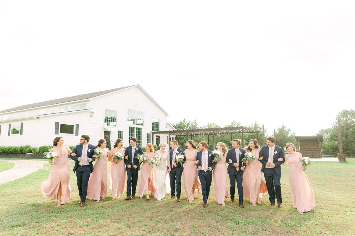 wedding party wearing pink dresses and navy suits in Texas