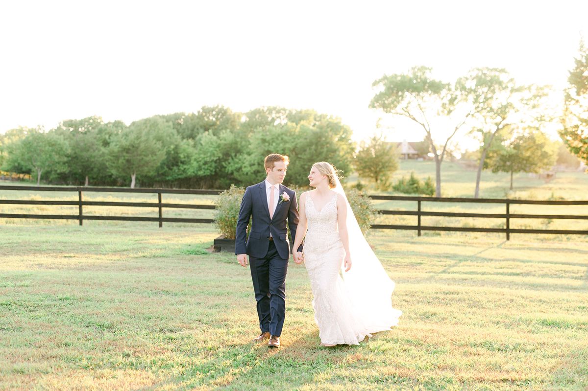 bride and groom walking during golden hour