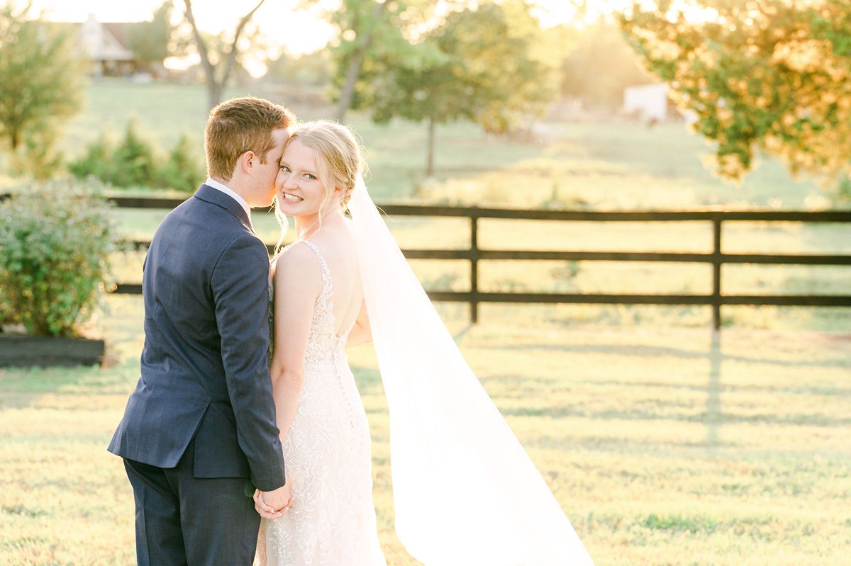 bride and groom cuddling during golden hour