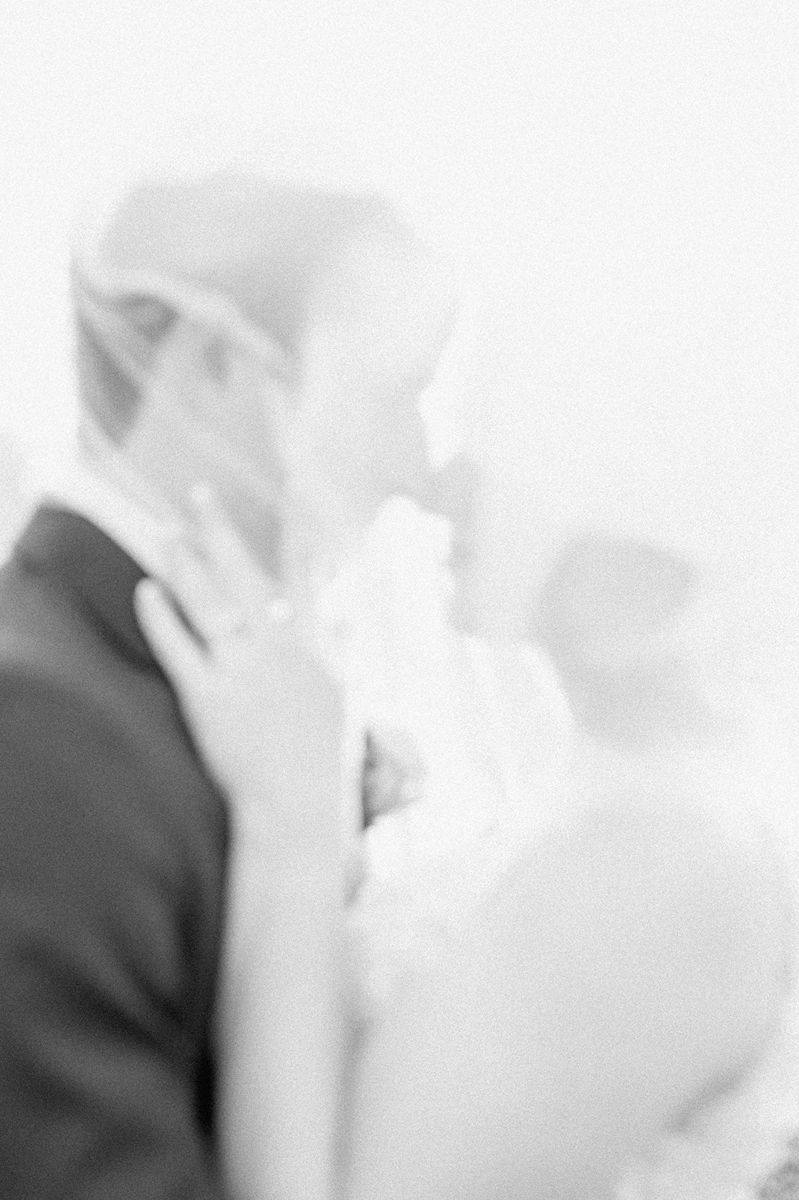 bride and groom under veil