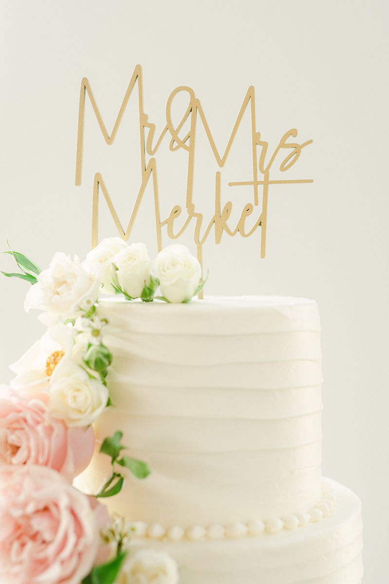 wedding cake with pink flowers and greenery at Venue 311 Plantersville Tx