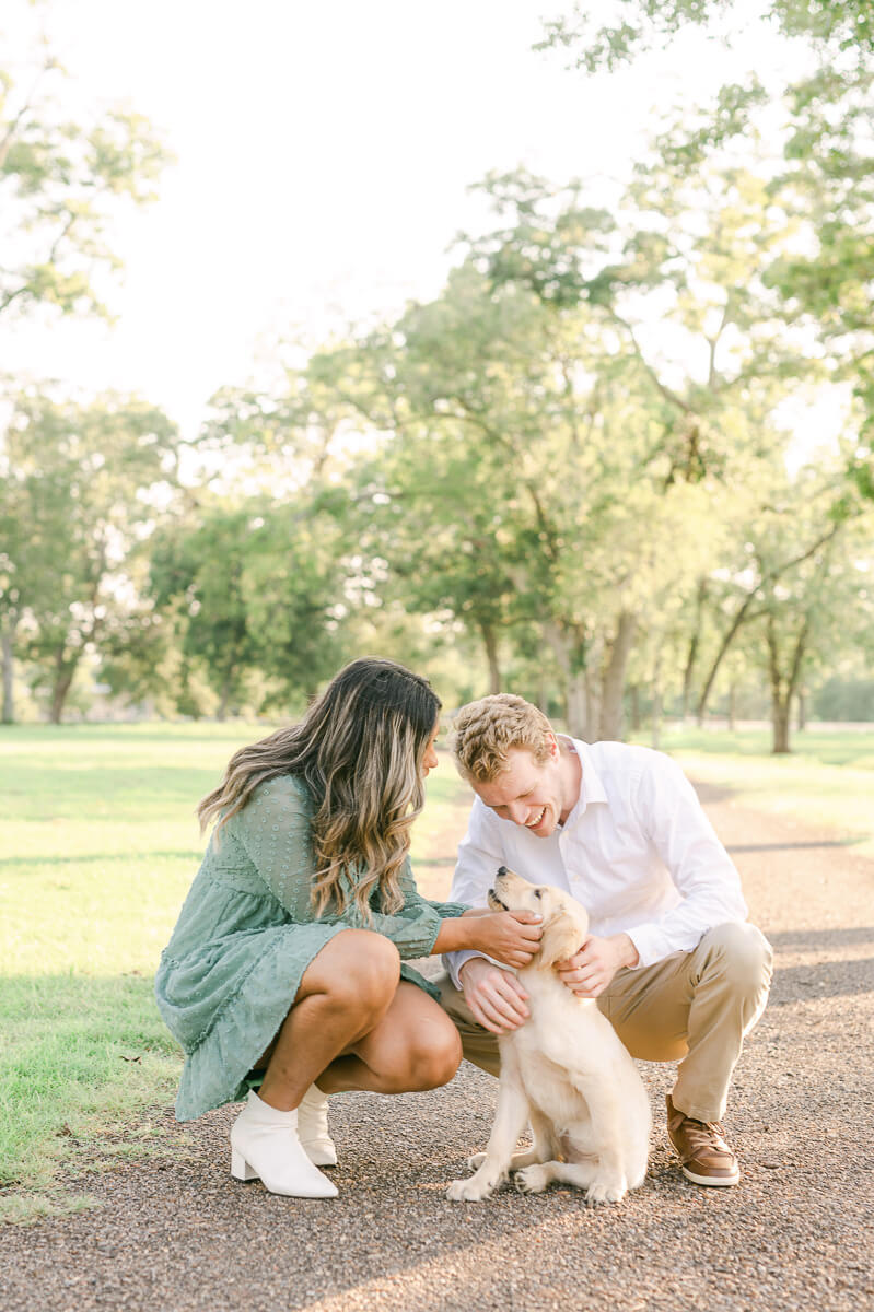 couple with their puppy at their engagement session with houston wedding photographer