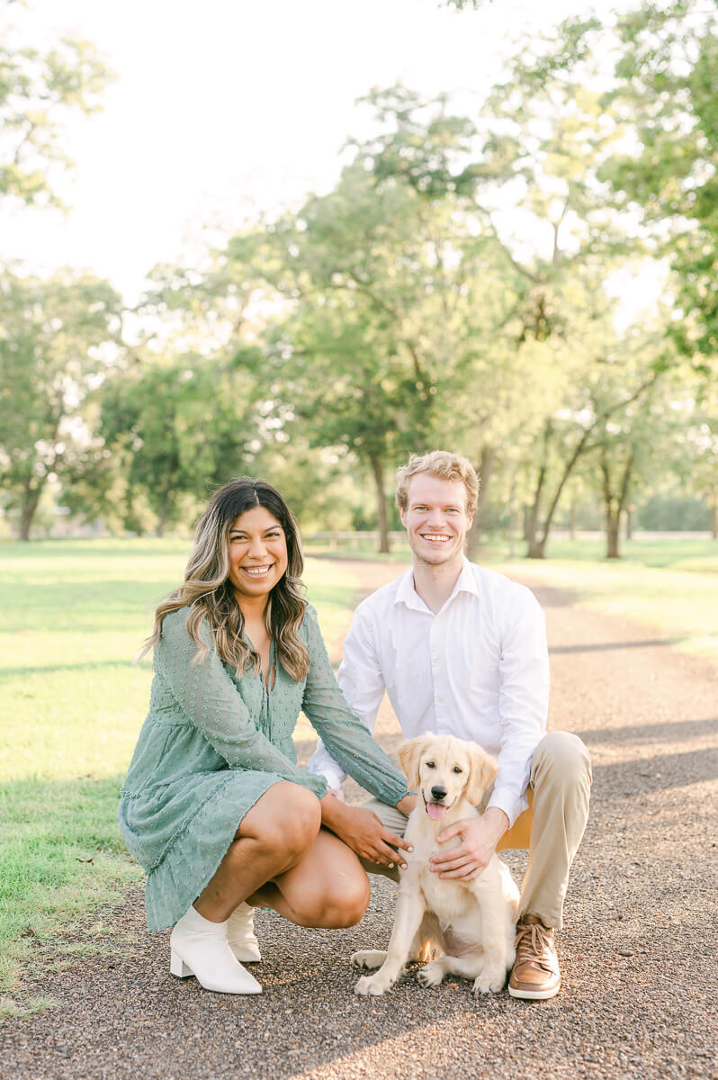 couple with their puppy at their engagement session with houston wedding photographer