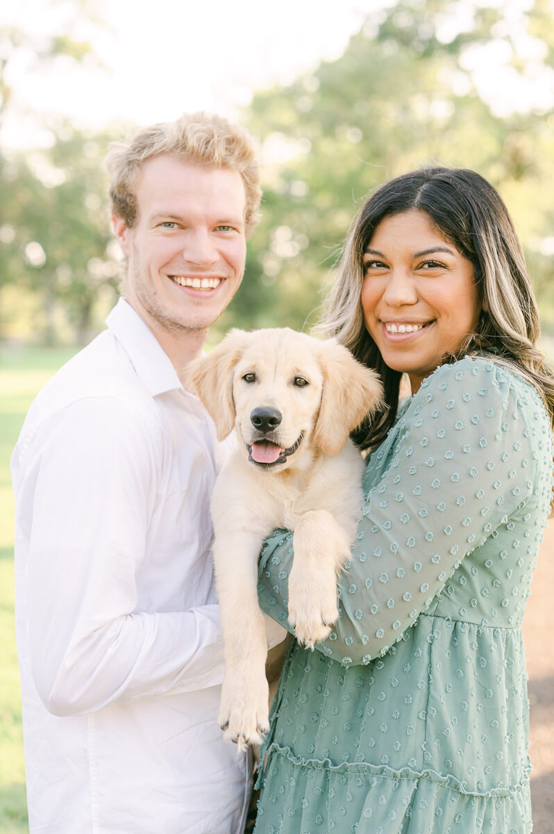 couple and golden retriever puppy during their houston engagement session 