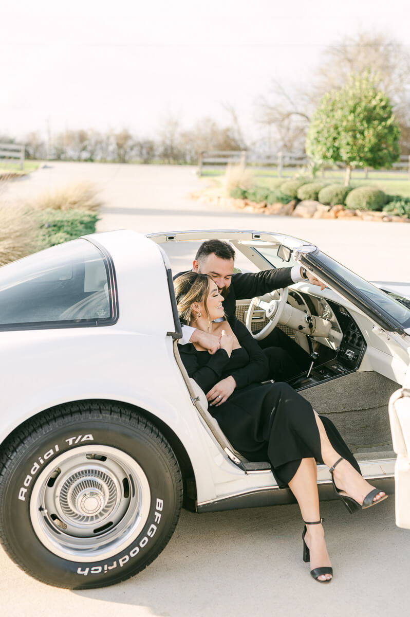 couple at the farmhouse wedding venue sitting in vintage car