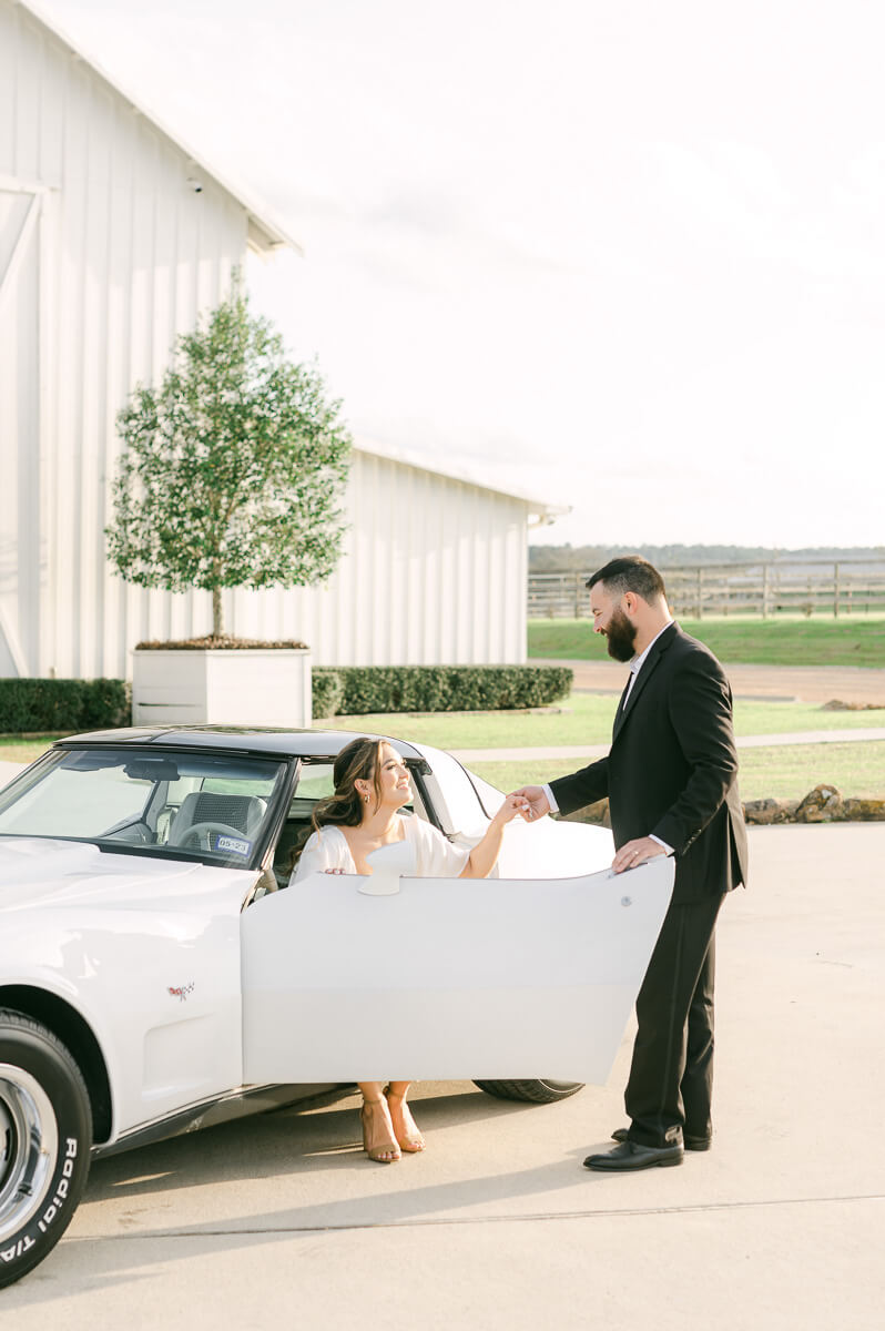 couple with white vintage car at the farmhouse