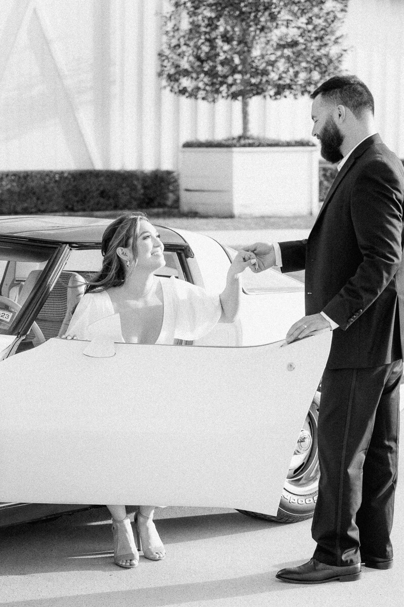 couple with white vintage car at the farmhouse