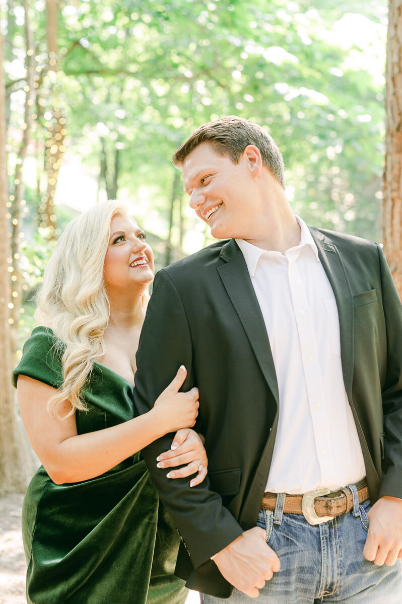 a couple in an emerald dress at big sky barn