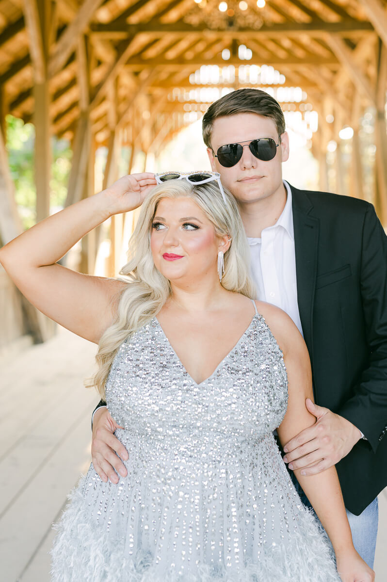 a fun couple wearing sunglasses at their engagement session