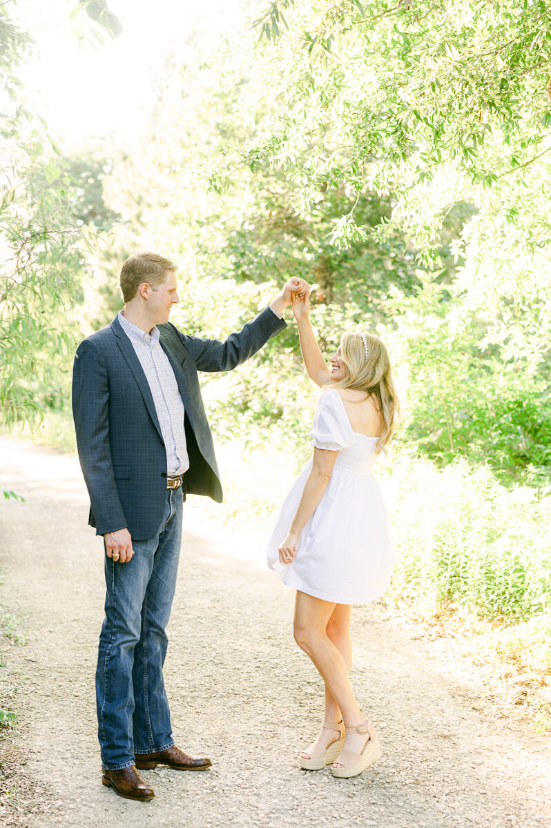 a couple spinning at their houston engagement session