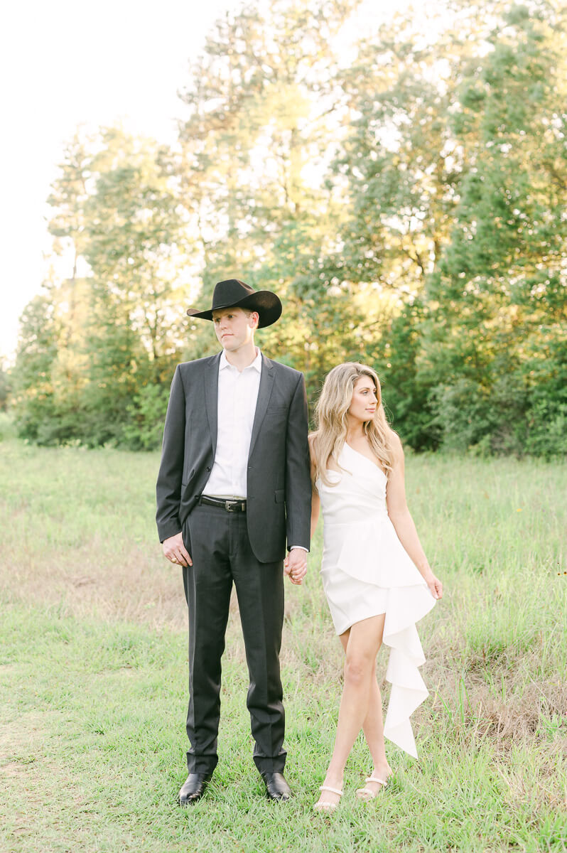 a couple wearing a suit and cowboy hat