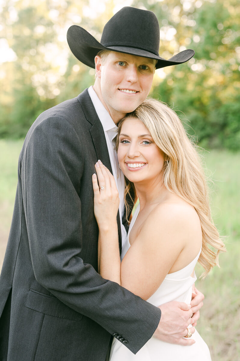 a couple wearing a suit and cowboy hat