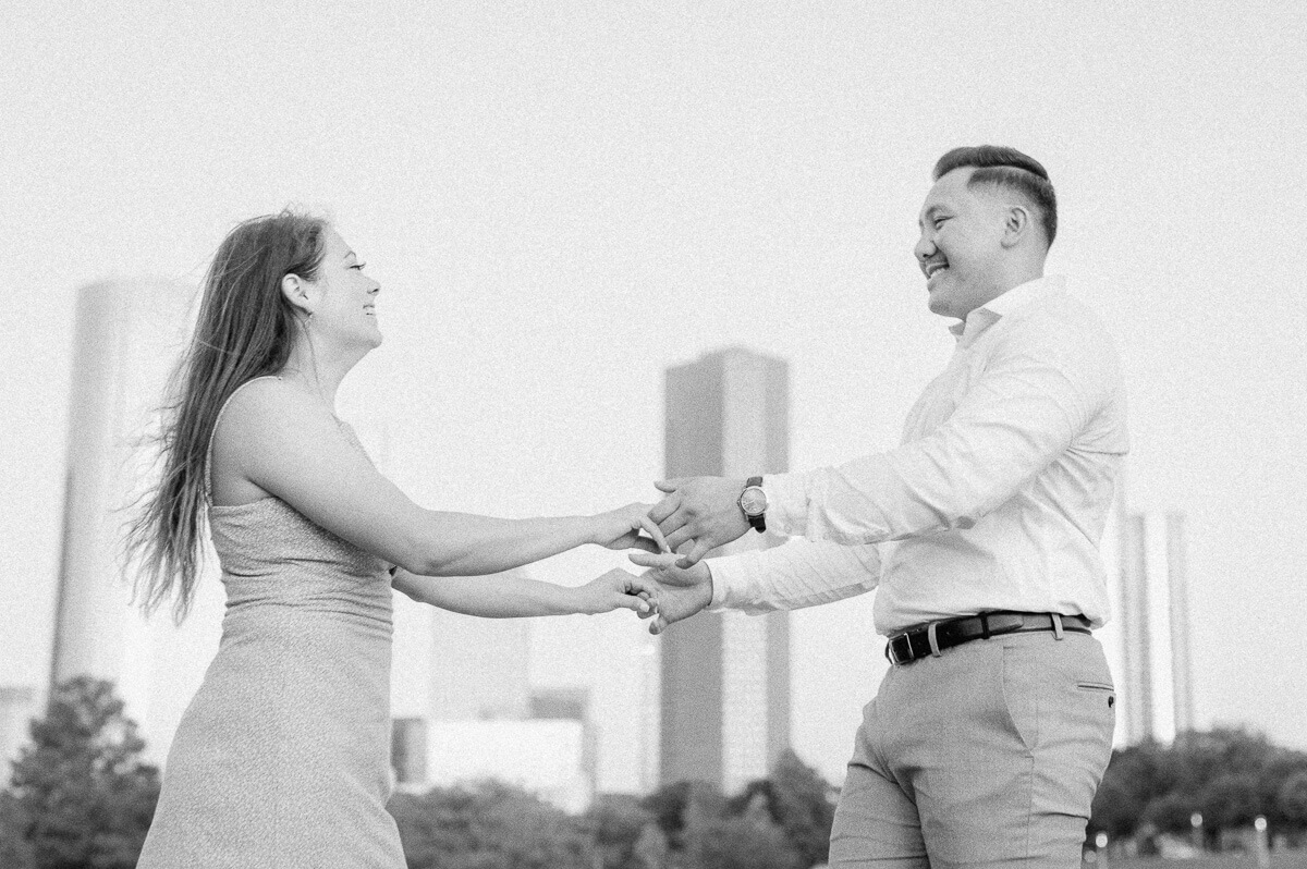 a couple in front of the downtown houston city skyline