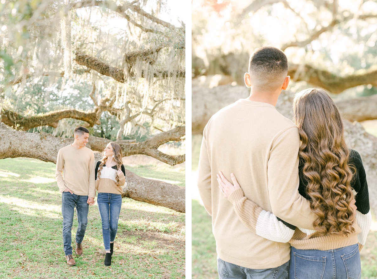 a couple standing in front of a Spanish moss tree 