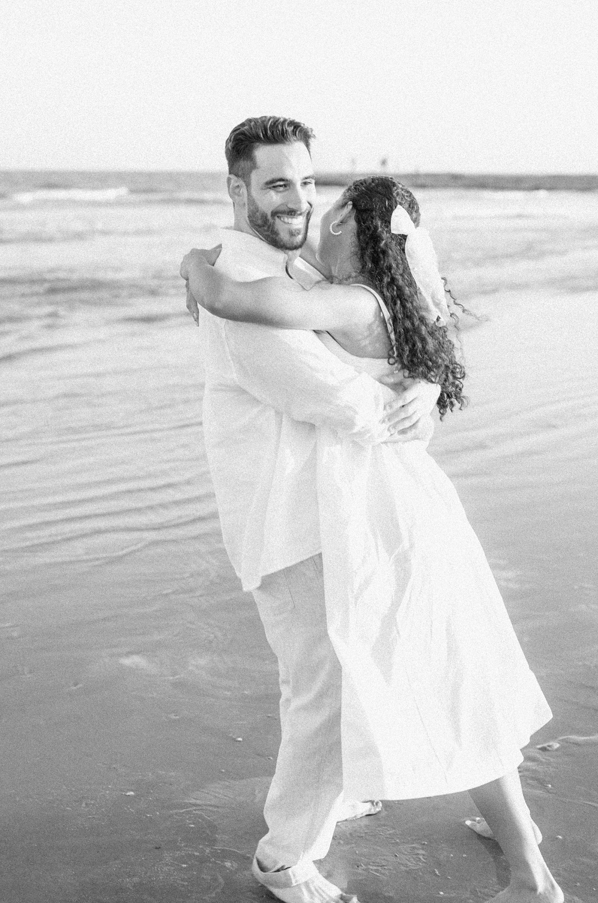 Couple spinning on the beach by Houston wedding photographer Eric & Jenn Photography