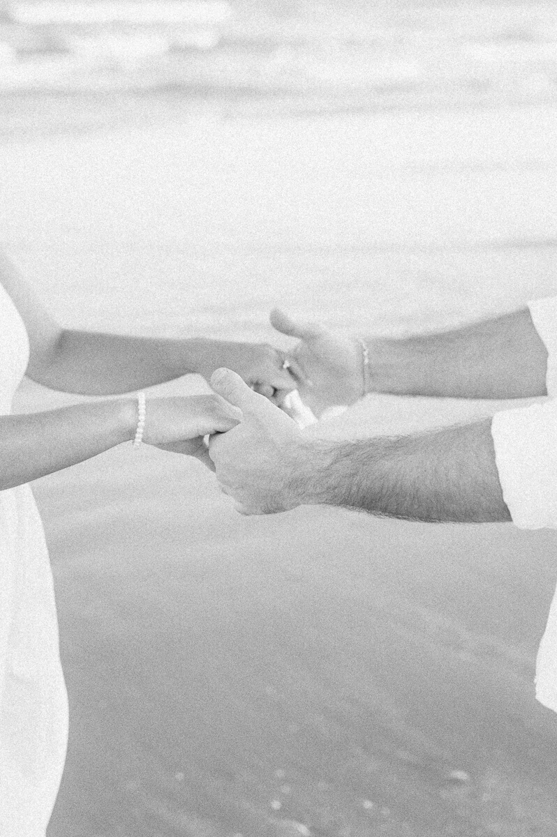 Black and white photo of couple holding hands