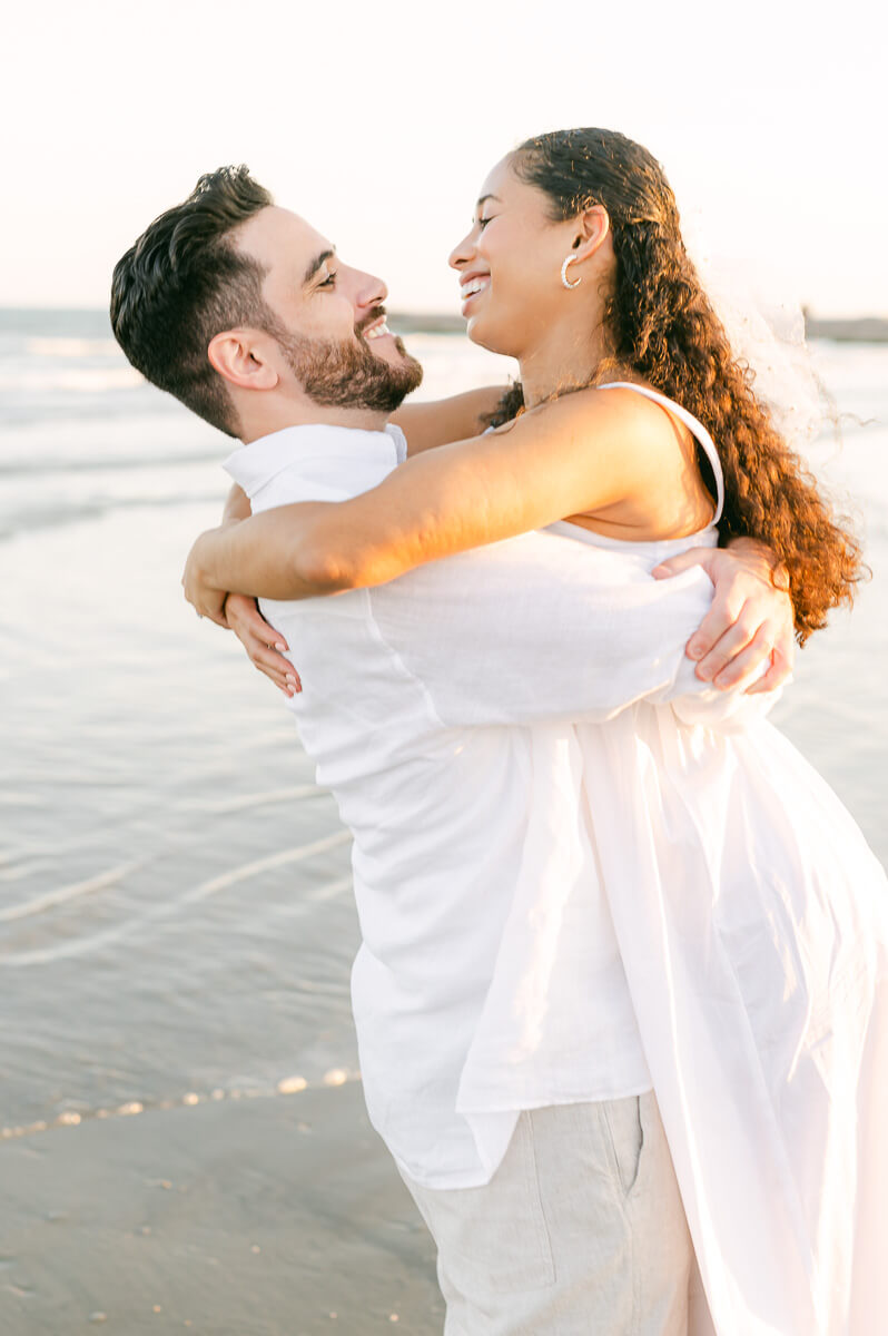 Couple spinning on the beach by Houston wedding photographer Eric & Jenn Photography