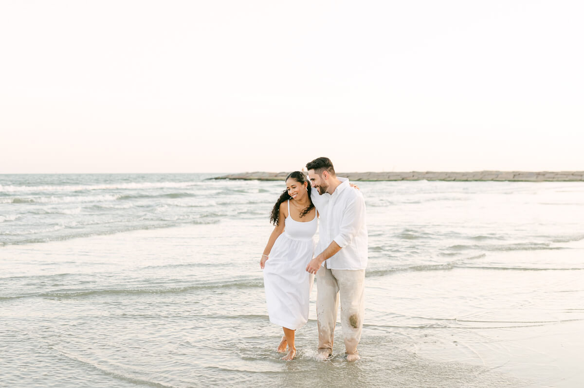 Couple walking on the beach during their Galveston engagement session