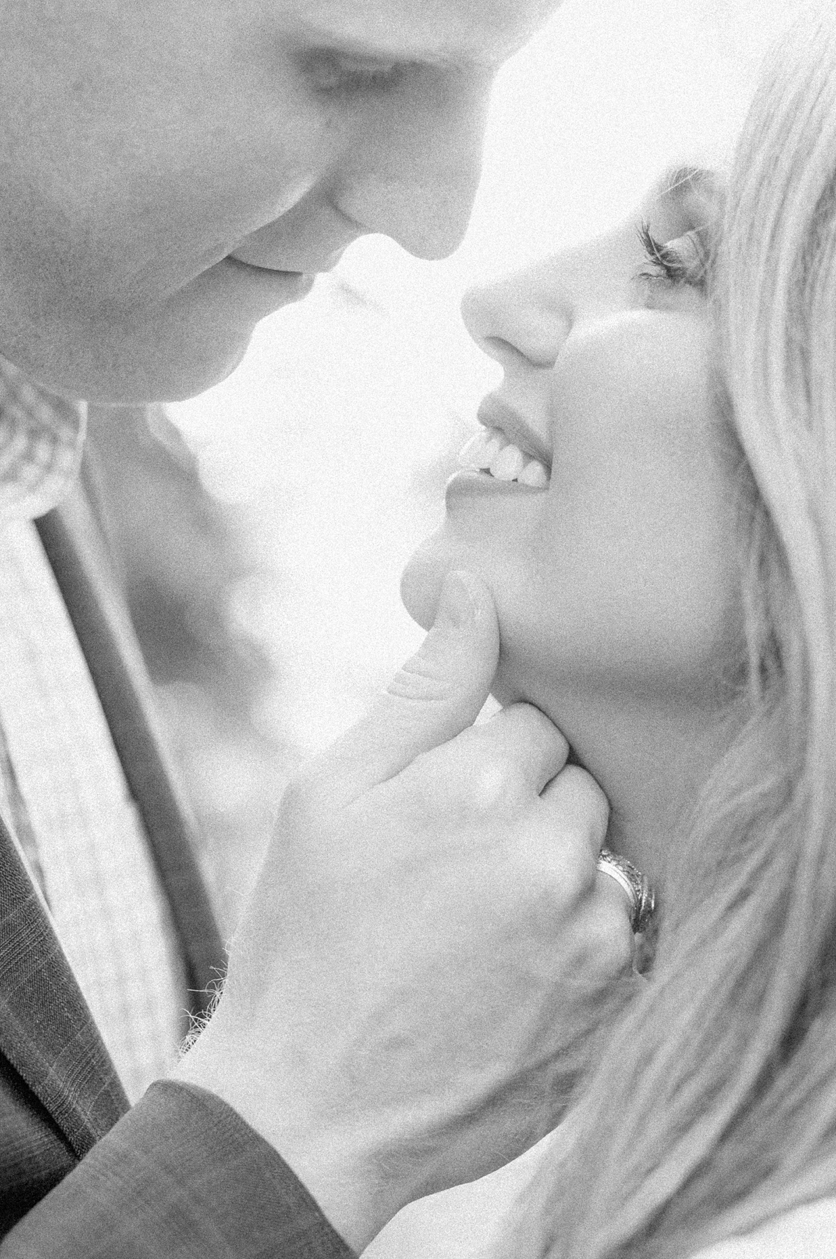 a close up black and white photo of a couple during their engagement session