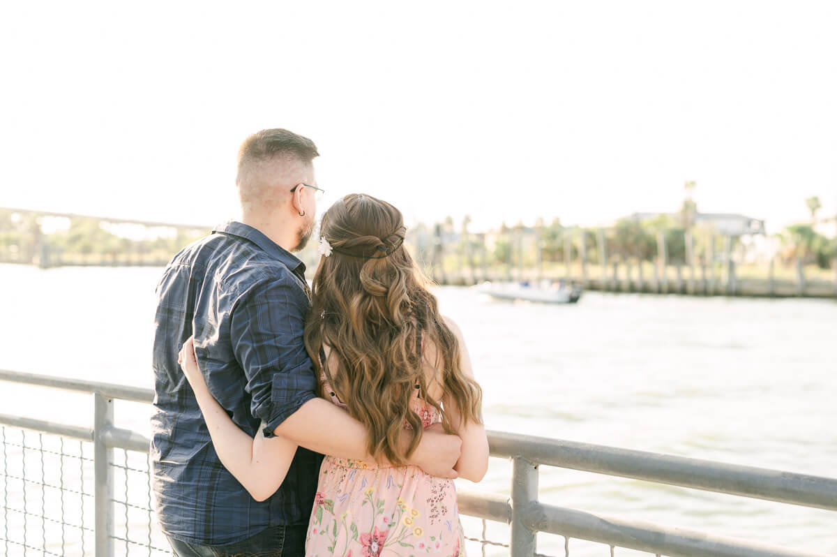 a couple looking out on the kemah boardwalk