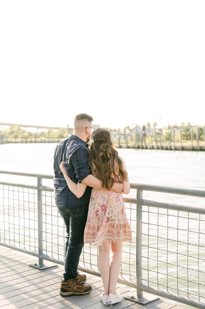 a couple looking out on the kemah boardwalk