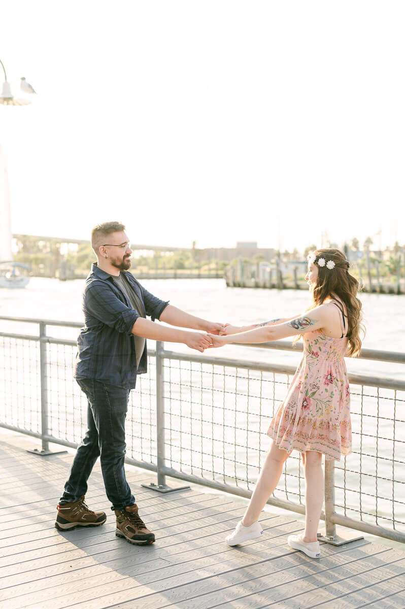 a couple with the kemah boardwalk in the background